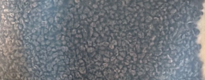 Close-up of Hidayah CTC tea granules through the pouch window